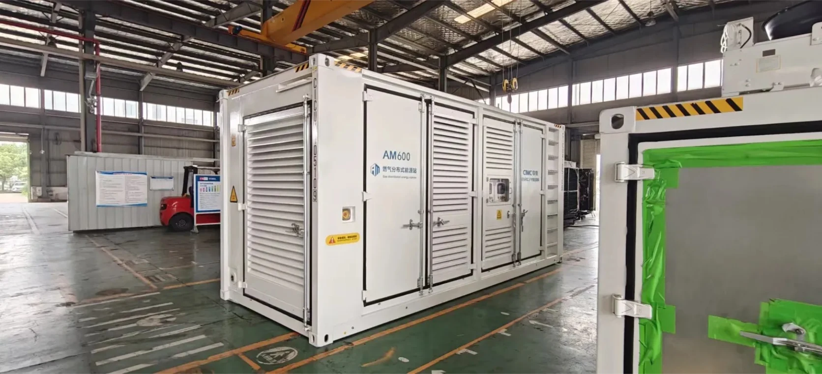 Actual AM600 gas generation package inside the factory, showing its enclosure and service doors
